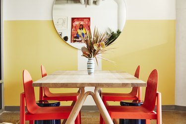 Photograph of yellow space with red chairs