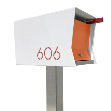 Orange and white midcentury modern mailbox with modern house numbers