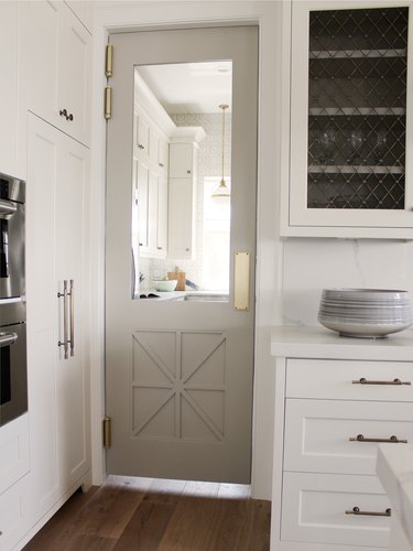 Gray kitchen color idea with gray pantry door and white cabinets