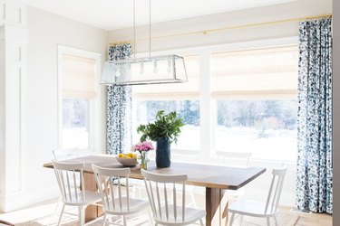 farmhouse-style dining room with blue floral curtains