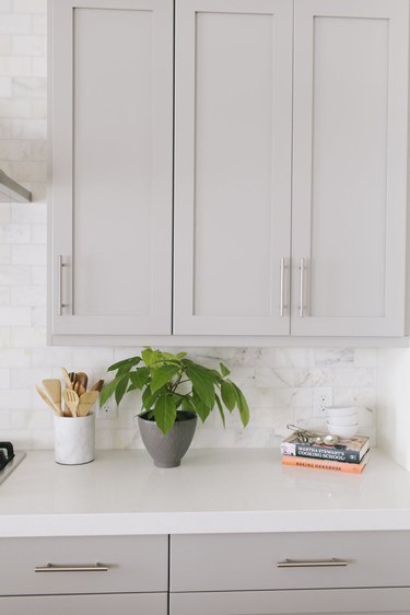 Gray kitchen color idea with gray cabinets and marble backsplash