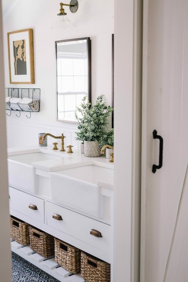 Farmhouse bathroom storage designed by Lynzy Co. with under the sink storage