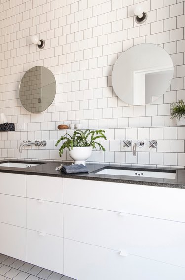 white bathroom with black countertops