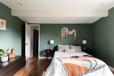 Boho-inspired bedroom with green walls.