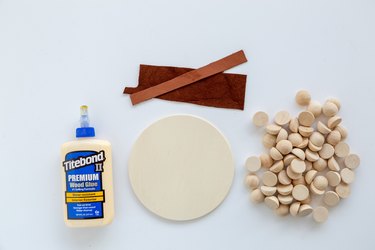 Materials to make a modern wood trivet using wood beads and glue.