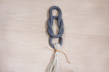Tying leather cord around tassel