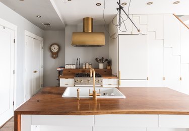 wood minimalist kitchen island with brass fixtures