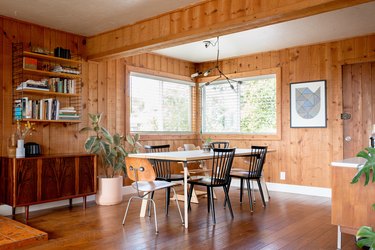 dining room with wood paneling and hardwood floors