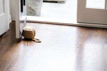 dark hardwood flooring in front of open door