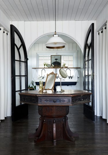 modern farmhouse bathroom idea with vintage table and trough sink