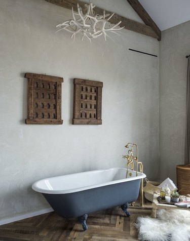 modern farmhouse bathroom idea with blue clawfoot bathtub