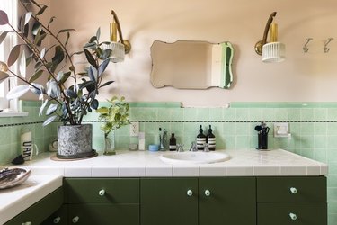 bathroom space with green and white tile