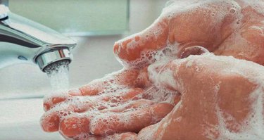 Washing spray foam off hands.