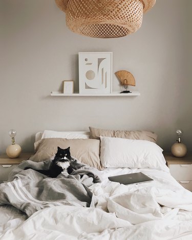 beige bedroom with Ikea Sinnerlig pendant and beige pillowcases