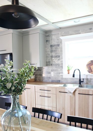 Scandinavian chic kitchen with light wood cabinets and double sink