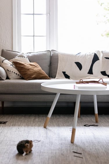 white coffee table in front of gray sofa in living room space