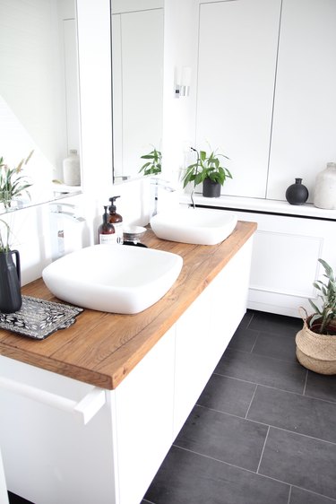white bathroom with wood countertop