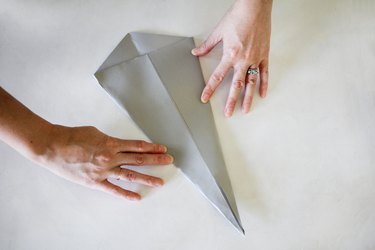 Flattening paper into cone shape