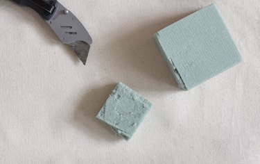 Cutting small square of floral foam