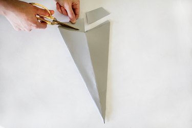 Cutting off excess paper from cone shape