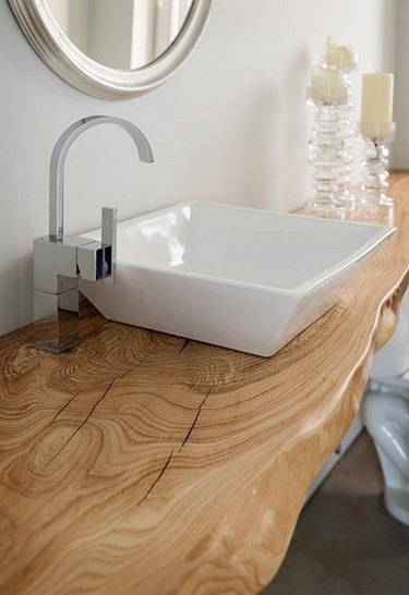 white bathroom with live edge wood countertop and chrome fixtures