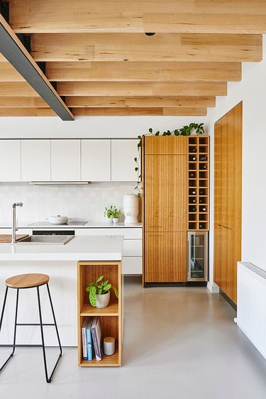 concrete kitchen flooring and exposed wood ceiling beams