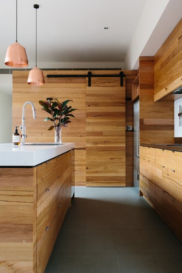 concrete kitchen floor in minimalist kitchen with wood cabinetry