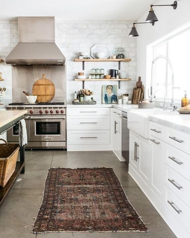 modern kitchen with concrete flooring topped with runner