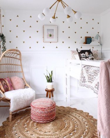 pink kids bedroom idea with midcentury chandelier and rattan chair