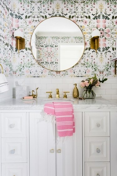 bathroom backsplash idea with white subway tile and floral patterned wallpaper