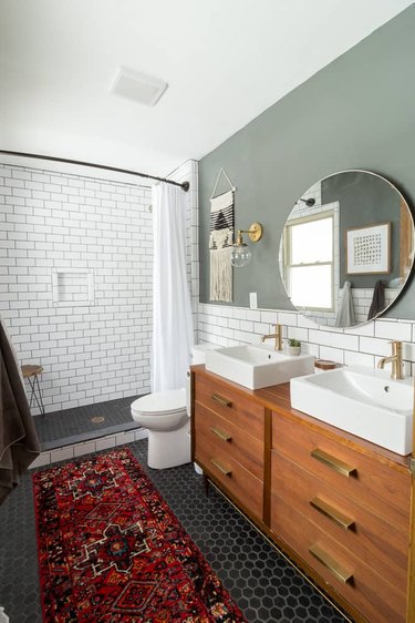 Double bathroom vanity with white vessel sinks and subway tile backsplash