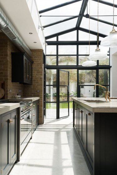 industrial kitchen with concrete countertop and blue cabinets