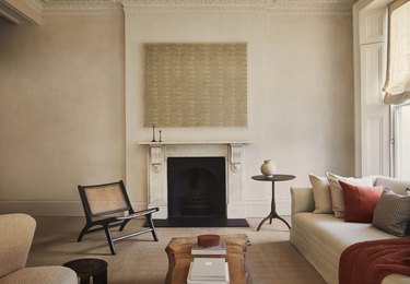 beige living room with warm red decor accents