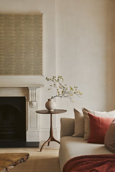 beige living room with warm red decor accents