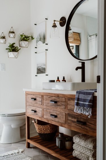 wooden industrial bathroom vanity with black fixtures