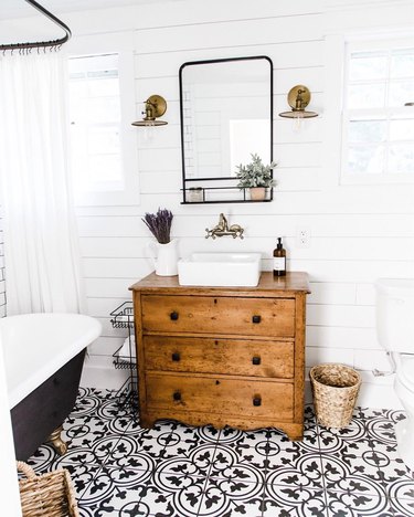 small farmhouse bathroom idea with patterned tile floors and repurposed vanity