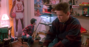 boy hanging out with friend and spider in his room, still image from home alone set