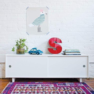 White console decorated with colorful toys