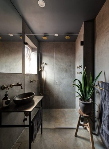 Deep grays and concrete create instant relaxation in this master bathroom.