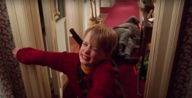 little kid being grabbed by burglar, still image from home alone set