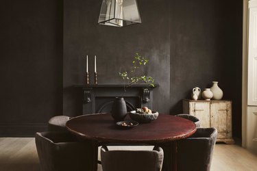 dramatic dining room with dark grey walls