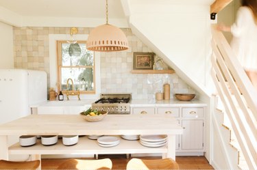 boho farmhouse kitchen island idea with shelving for dishware