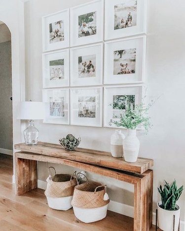 farmhouse entryway with wooden bench and gallery wall