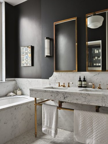 black and white bathroom with marble flooring and walls