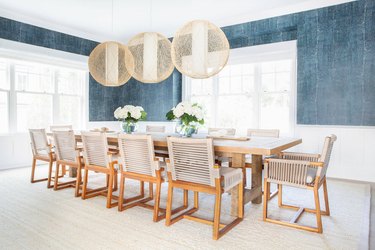Dining room wainscoting with blue wallpaper above by Chango & Co.
