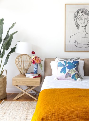 tropical bedroom with orange throw and accent pillows