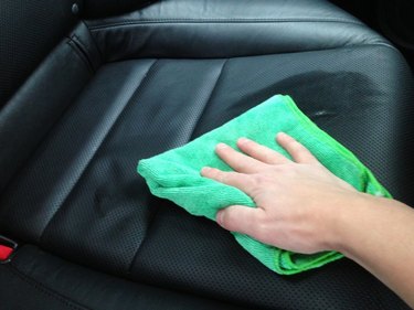 Cleaning leather car seat.