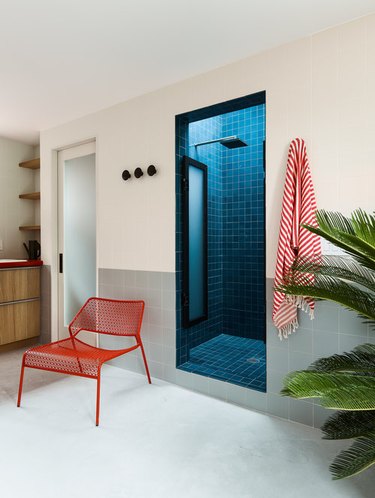 color block bathroom with royal blue shower and seafoam green wainscot