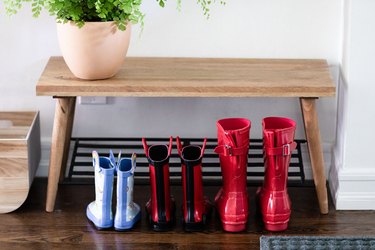 close up of rain-proof boots under a bench