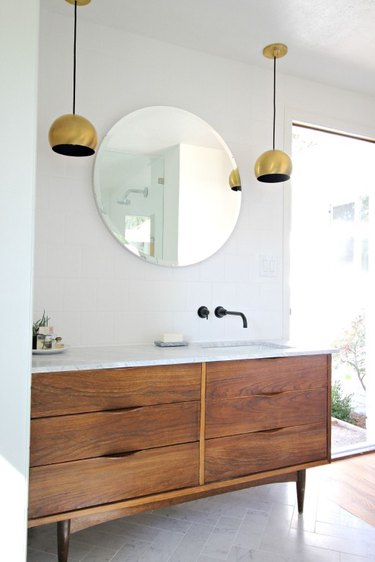 modern bathroom with marble flooring in herringbone pattern